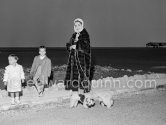 Elizabeth Taylor arriving at Nice Airport to spend a short holiday at Villa Fiorentina, Saint-Jean-Cap-Ferrat. With her were her two sons Michael and Christopher Wilding. Also travelling with her were her two doggies. Nice 1957. - Photo by Edward Quinn