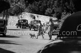 Jimmy Donahue, an heir to the Woolworth estate, and Wallis Simpson, Duchess of Windsor with the Windsor’s Pug. Although openly gay, Donahue claimed he had a four-year affair with the Duchess. Cannes 1953. Cars: Citroën Traction Avant , Peugeot, Renault 4CV, Cadillac - Photo by Edward Quinn